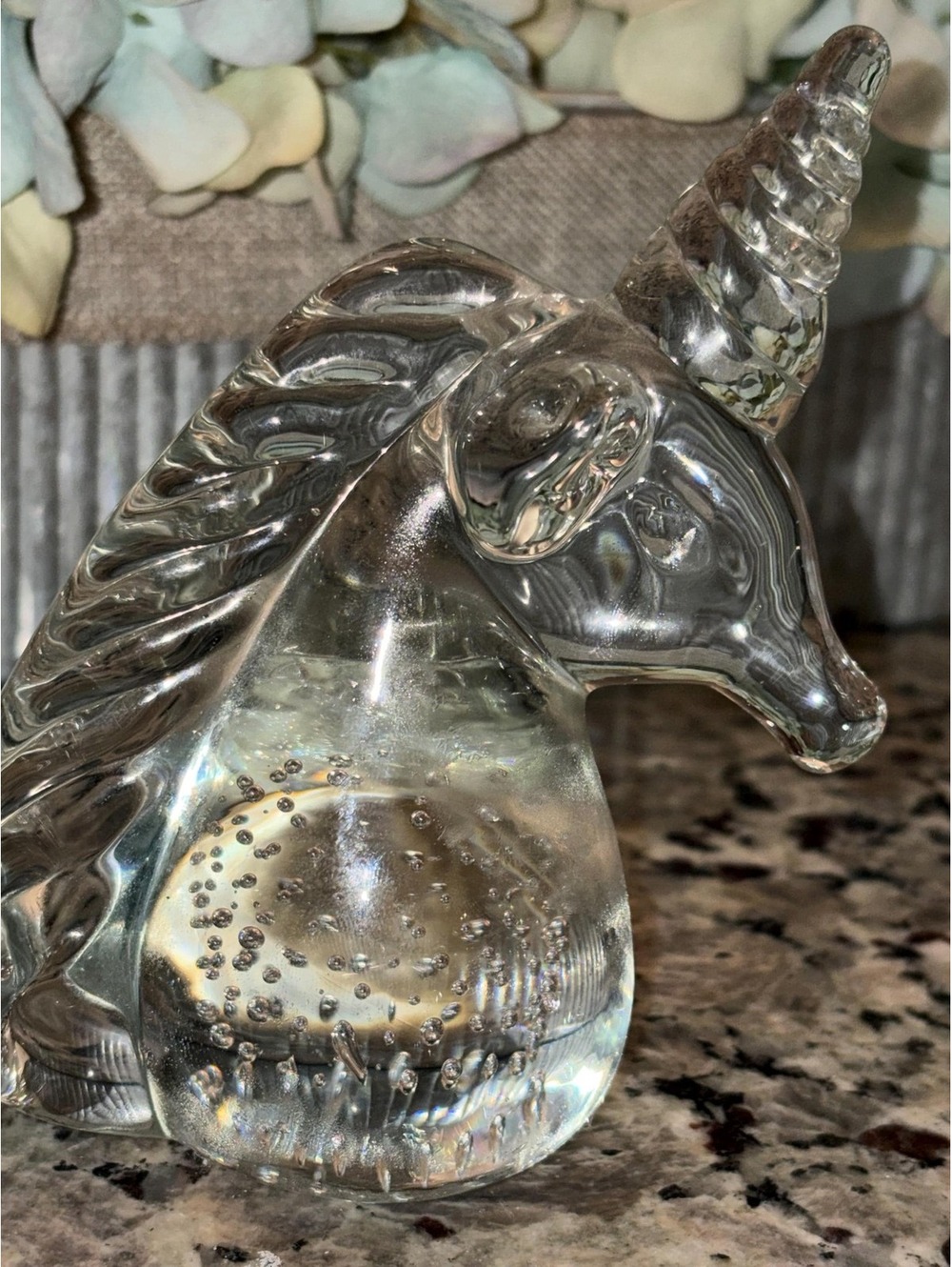This is a vintage clear glass unicorn head figurine with controlled bubbles.